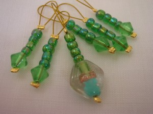 Green glass bead stitch markers with feature bead